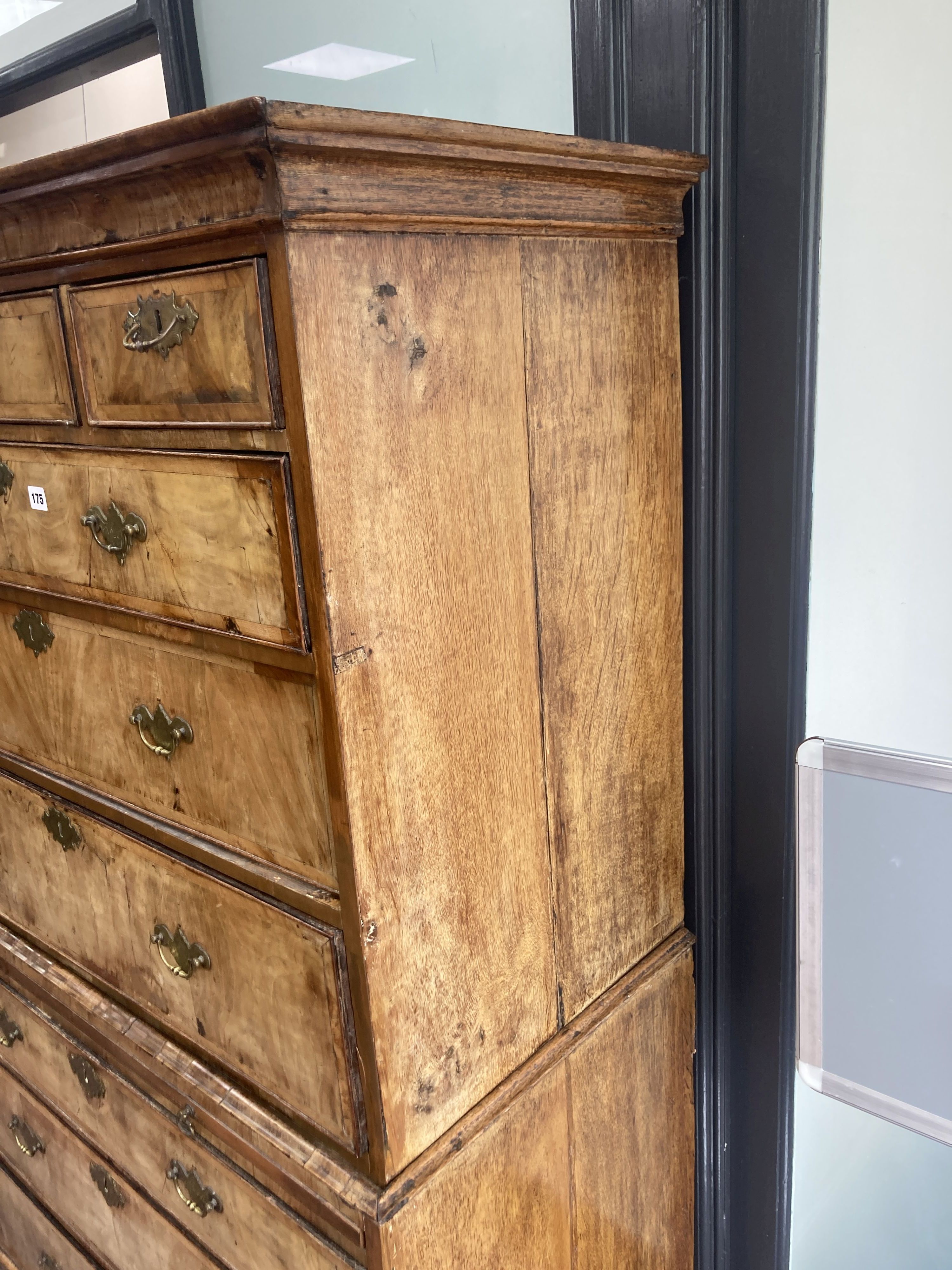 An early 18th century banded walnut tallboy, with oak sides, fitted three small and six long drawers with a brushing slide, width 105cm